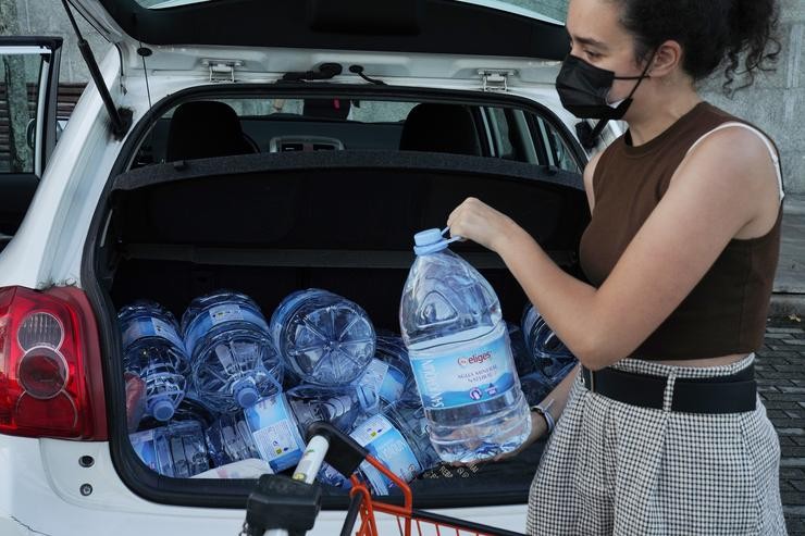 Unha muller carga con varios bidóns con auga, a 11 de setembro en Santiago de Compostela, A Coruña (Galicia).. Álvaro Ballesteros - Europa Press / Europa Press