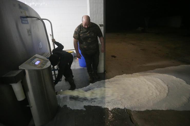 Un gandeiro verte o leite ao chan despois de que a industria láctea teña que parar a súa actividade, a 17 de marzo de 2022, en Vilela, Outeiro de Rei, Lugo 