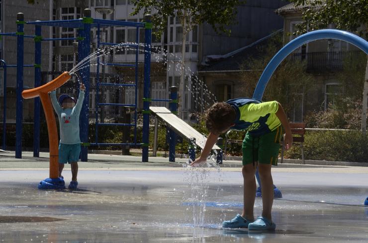 Dous nenos xogan no parque do Cruceiro, a 8 de agosto de 2023, en Ourense, Galicia 