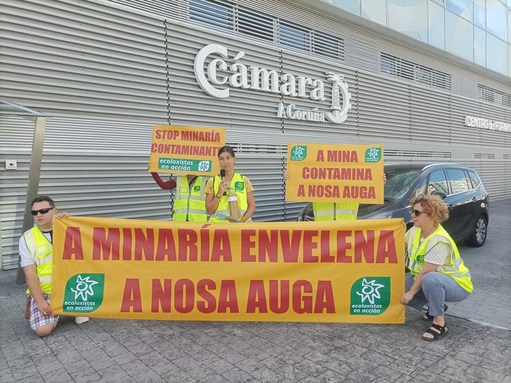 Activistas de Ecoloxistas en Acción levan botellas de auga recollida das verteduras das minas de San Fins e Touro á sede da Cámara Oficial Mineira de Galicia, e convidan a bebela ao representante deste organismo 